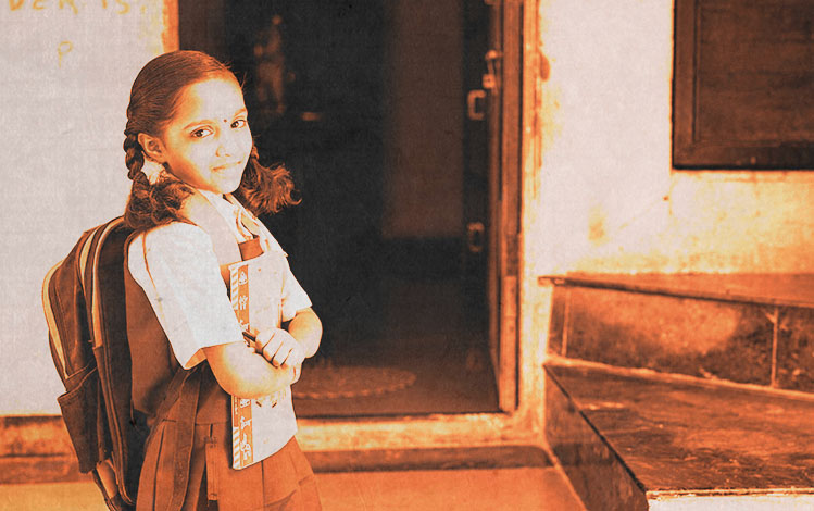 Young school girl in front of classroom door