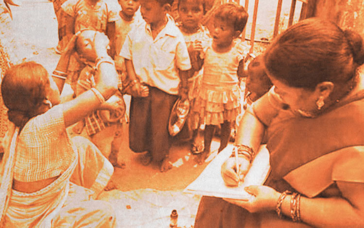 Women Anganwadi workers providing medical attention to children