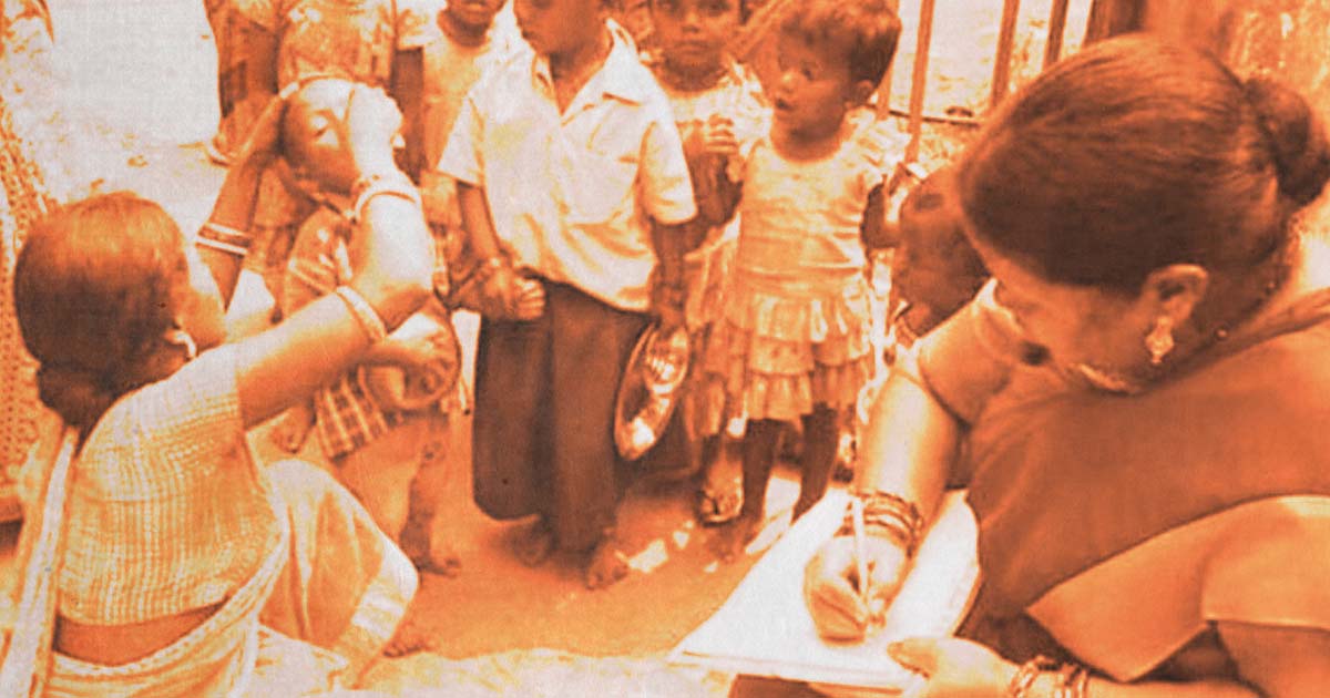 Women Anganwadi workers providing medical attention to children