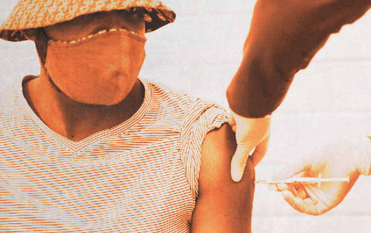 Doctor giving a patient a COVID vaccine shot to patient